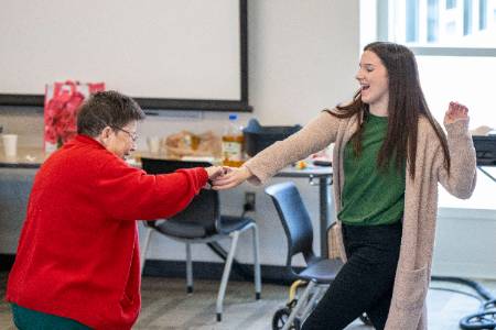 A patient dancing with a clinic worker.