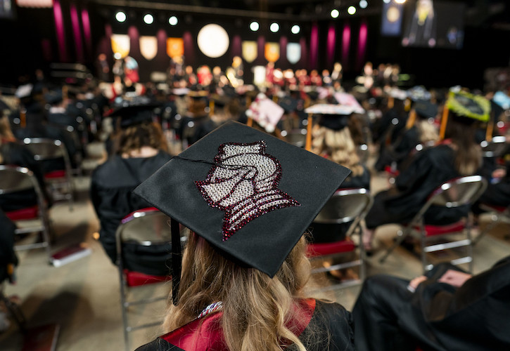 Graduate wearing cap with Knight Head art