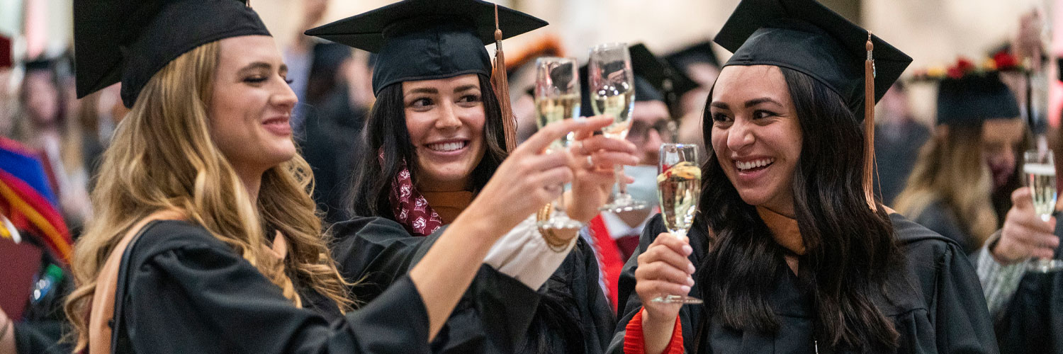 Recent graduates toast champagne