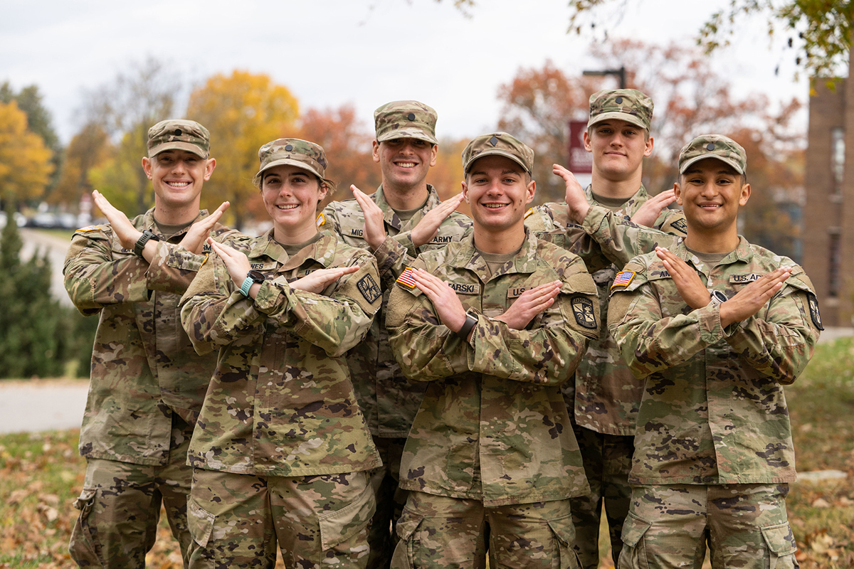 Military students doing the Swords Up pose in uniform