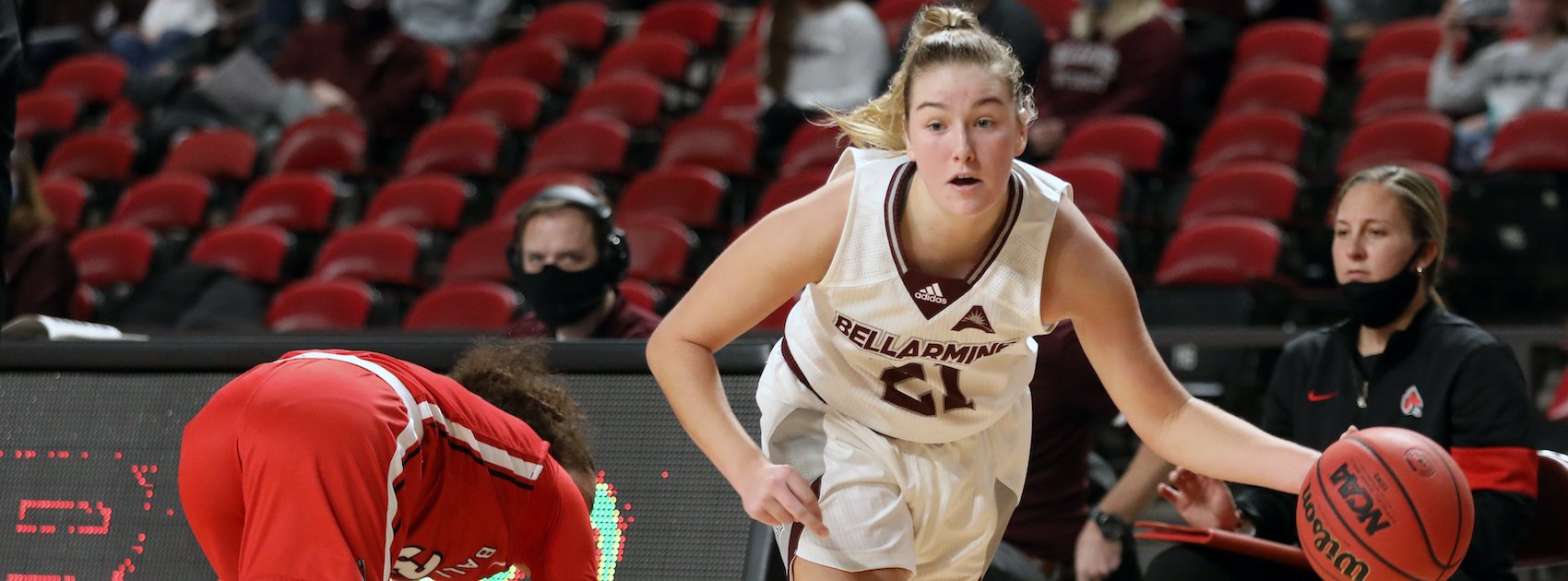 D1 Basketball women's basketball player dribbles a ball down the court