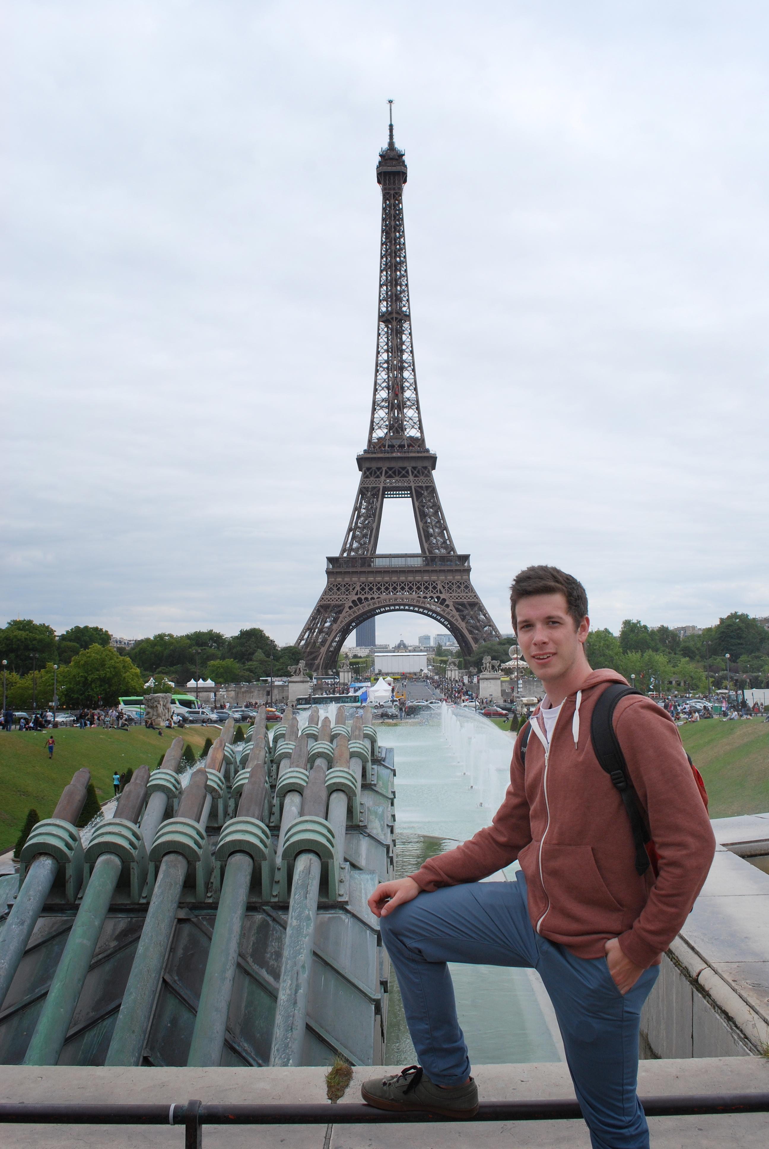 student poses with the eiffel tower in the background