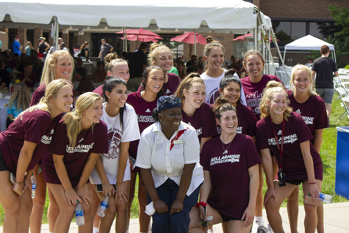 Sharon Gibson poses with the girls' volleyball team