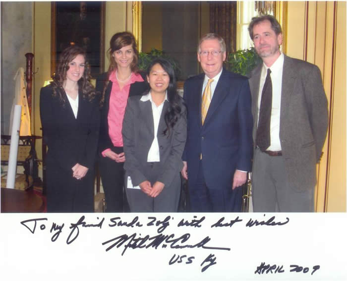 polaroid of sanda zolj standing with senator mitch mcconnell and colleagues