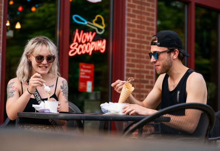 Man and woman enjoying ice cream outside