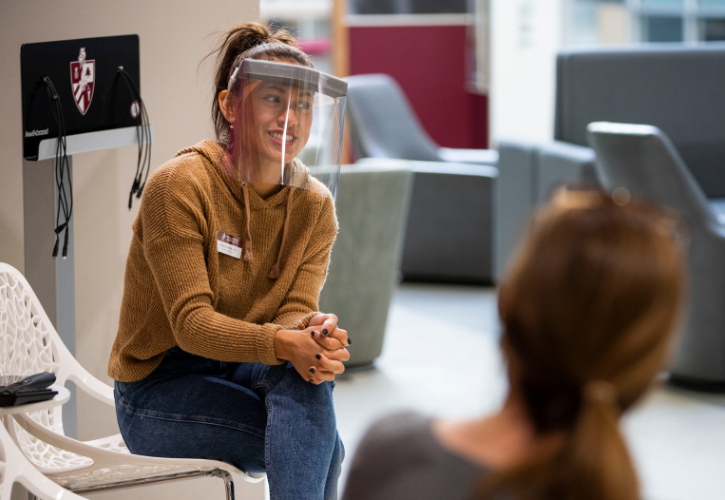 Bellarmine Admission Counselor with face shield greets families