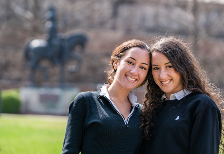 Jordan and McKenley next to the Knight Statue in the Quad