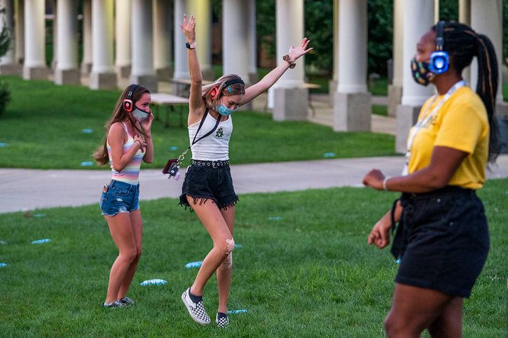 Students at a silent disco on the Quad