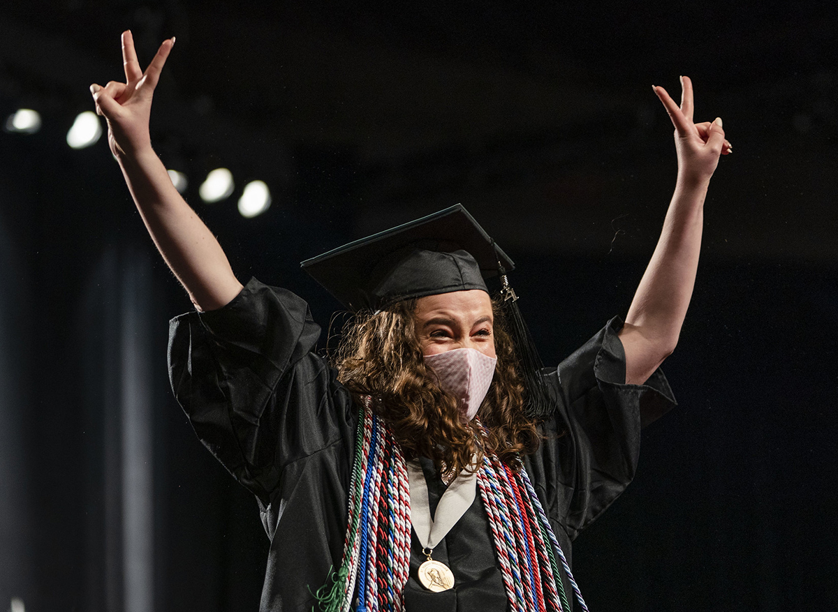 Elizabeth Lonnemann celebrates as she walks across the stage