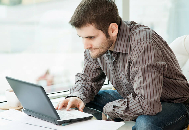 This image depicts a student researching online, could be searching for scholarships, filling out financial aid paperwork for college, etc.