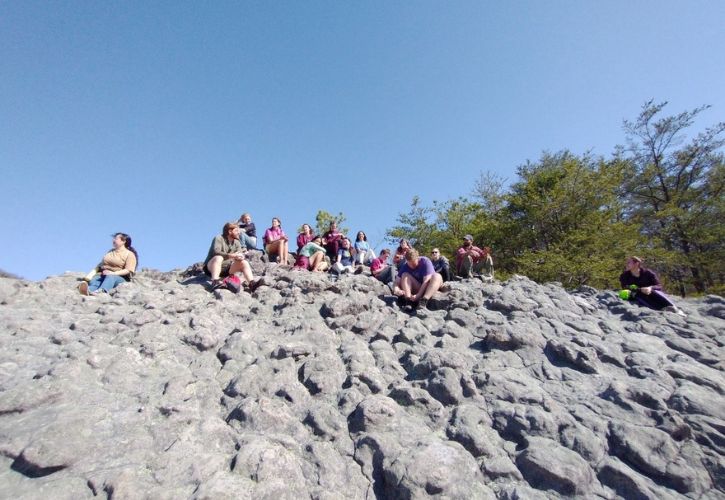 Environmental students, Professor Randy Strobo and tour guide Derrick Lindsay on the top of Knobby Hill