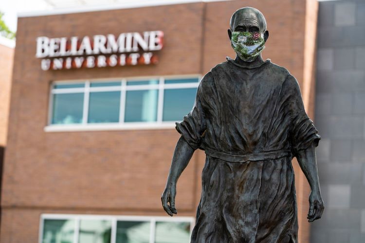 The Thomas Merton sculpture at Bellarmine University wears a mask to reflect coronavirus protections.