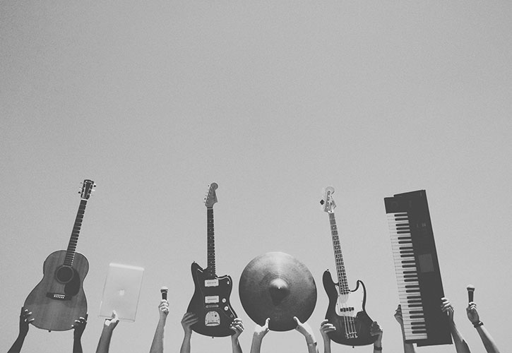 Grayscale image of hands holding instruments