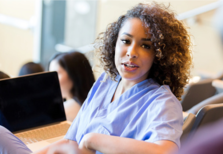 This image depicts a student who could be taking classes in pursuit of her second career as a nurse.