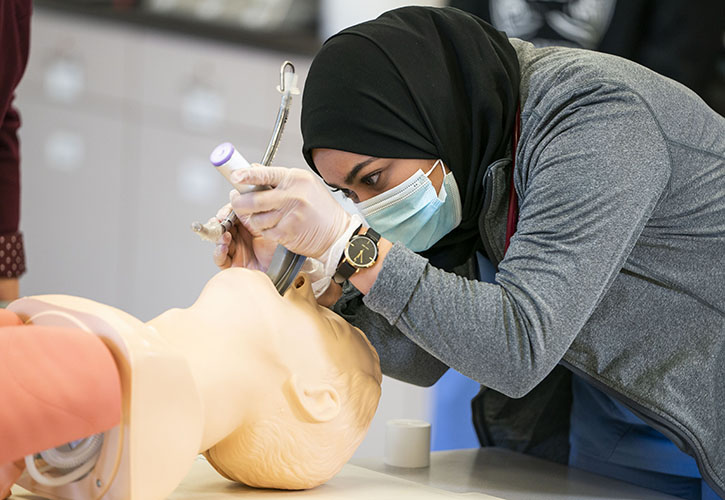 Respiratory therapy student intubates a simulated patient. 