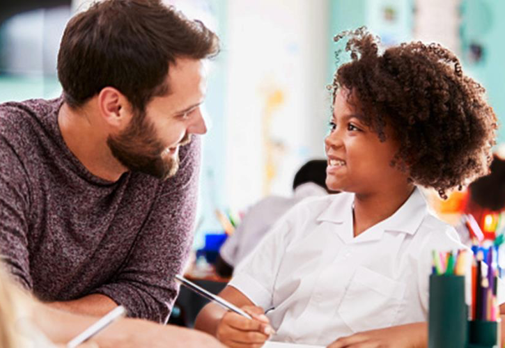 teacher working one-on-one with a student 