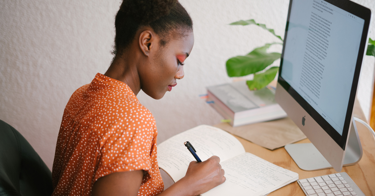 Black woman writing at a desk