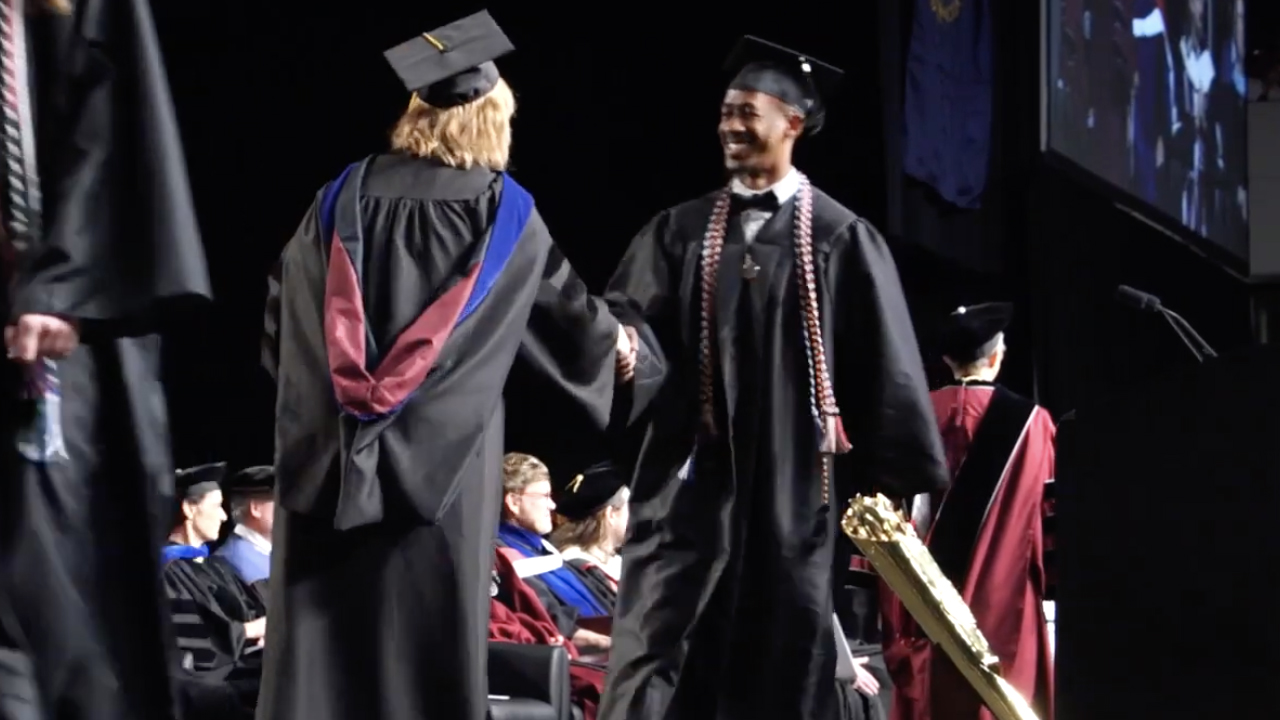 Graduates walking across the stage