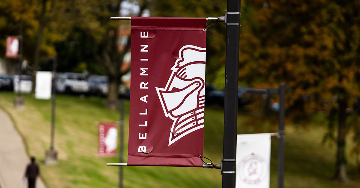bellarmine insignia on a banner attached to a pole.