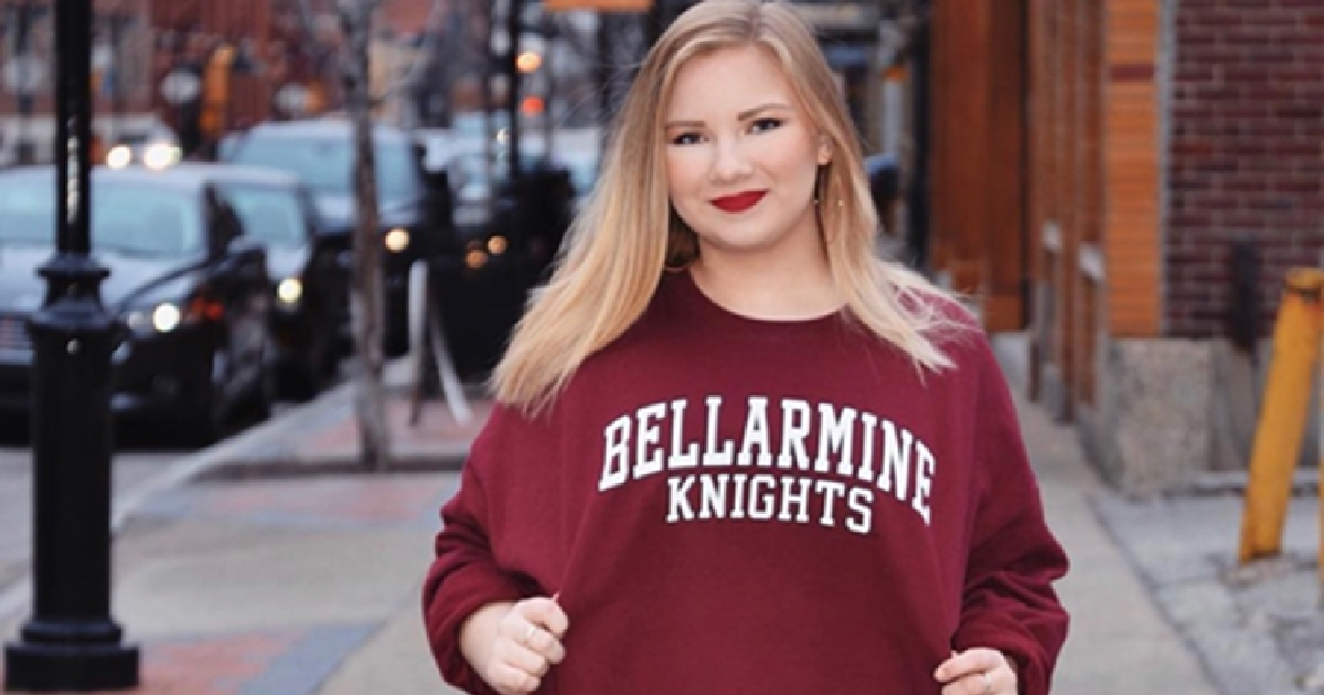 Anna Stanton proudly poses for the camera with her Bellarmine Knights sweatshirt