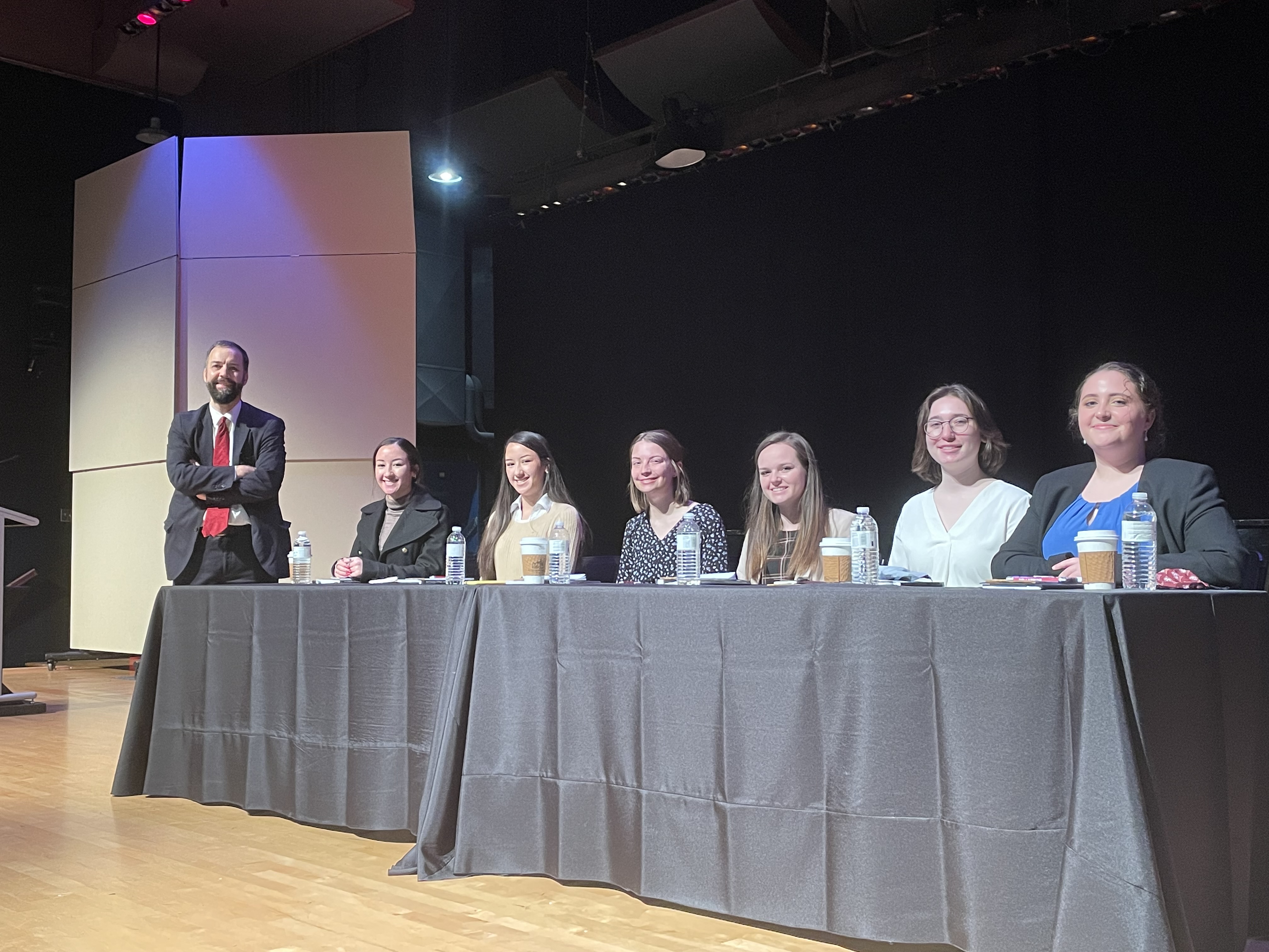 Constitutional Studies students sit at a table presenting a panel discussion