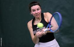 Student-athlete swinging tennis racket