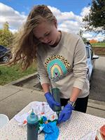 Student tie-dying a t-shirt