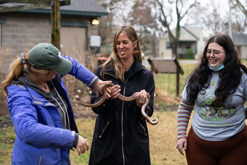 Dr. Cook holding a snake