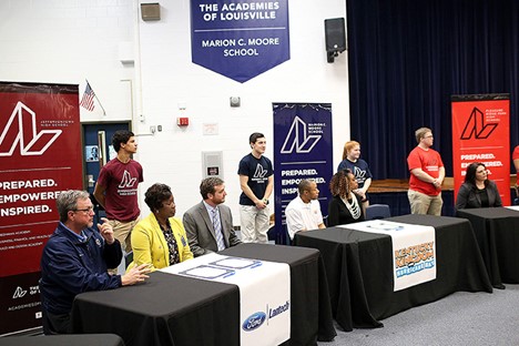 sponsors sit at booths at a STEM conference