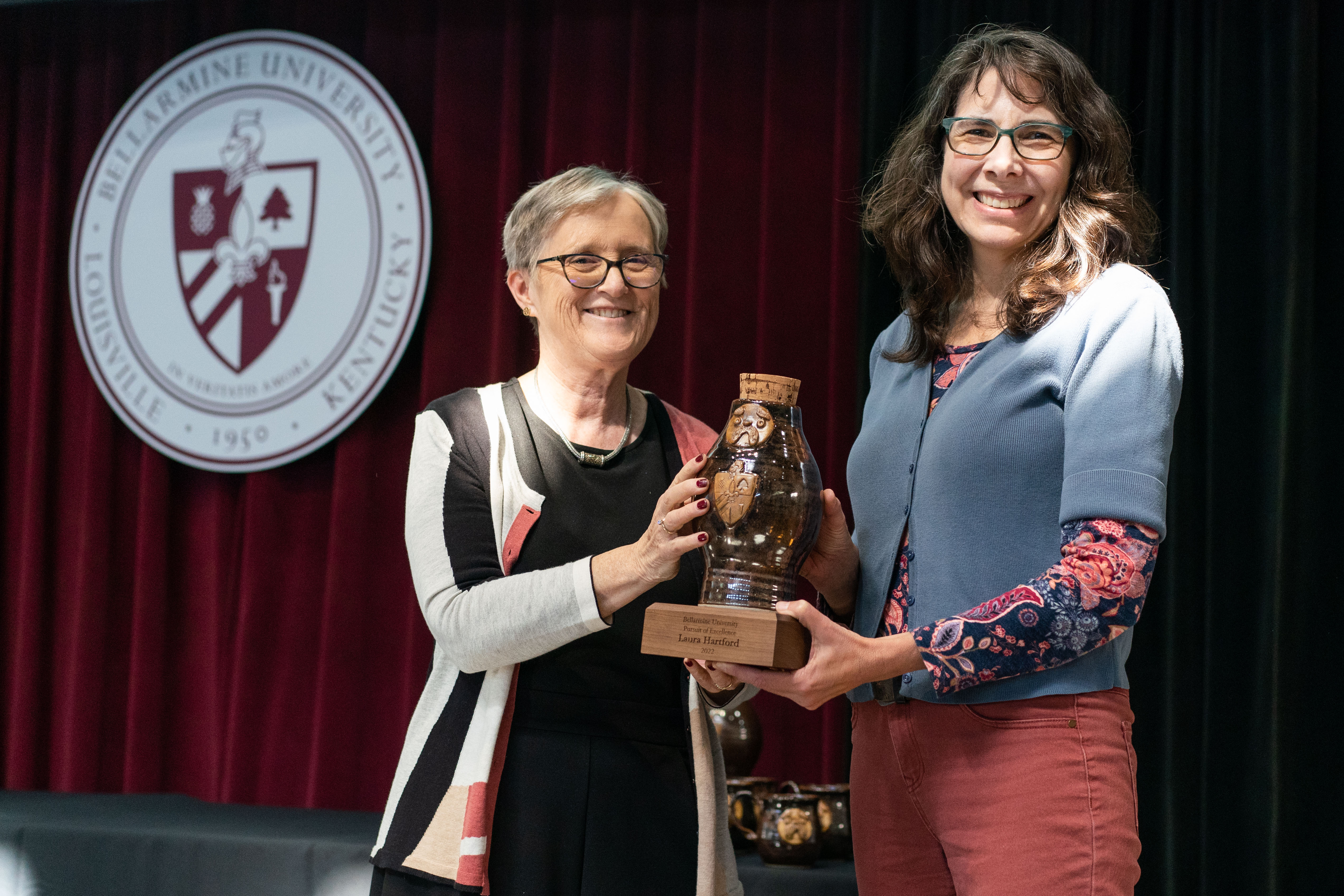 Laura Hartford receives award for Pursuit of Excellence.