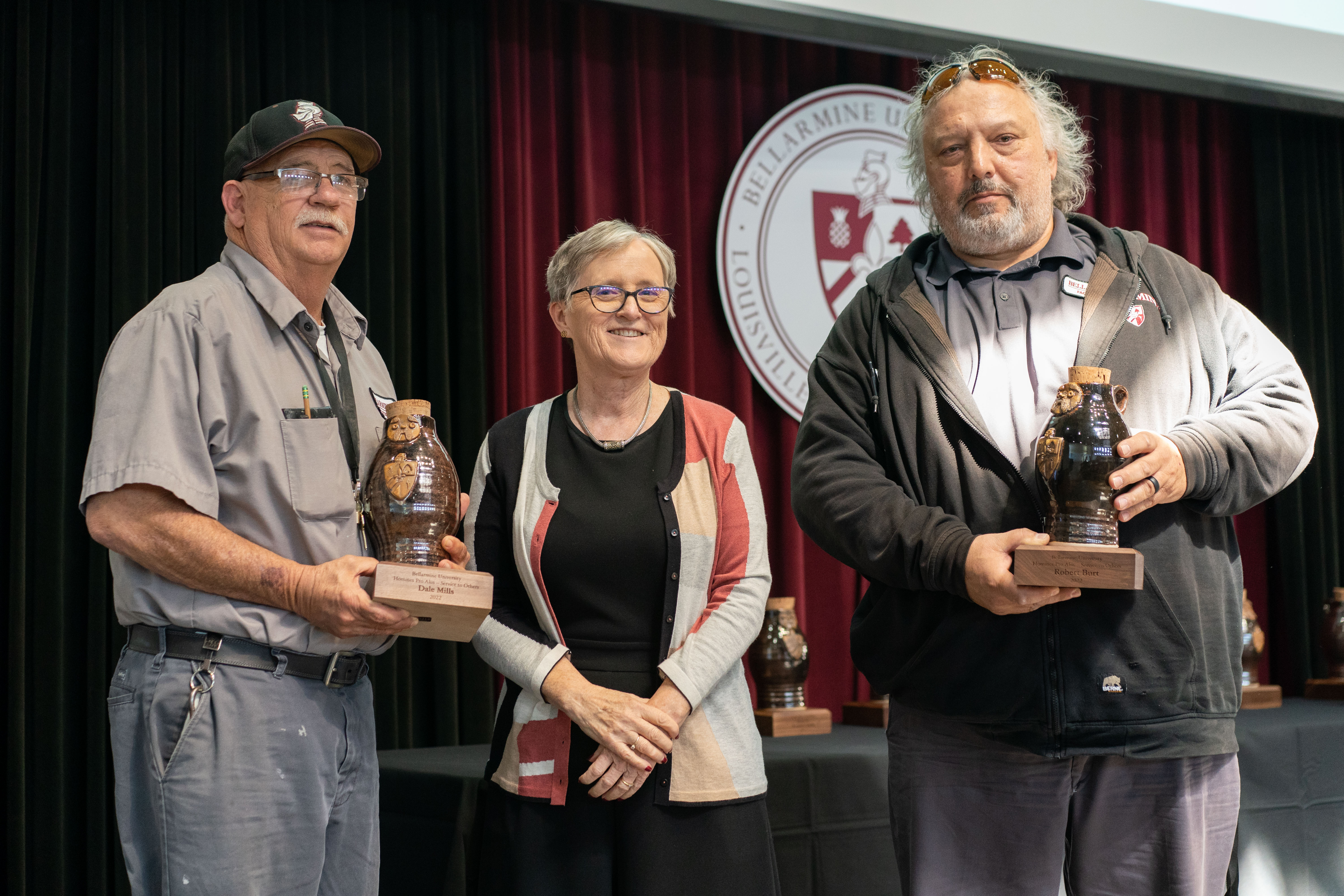 Robert Burt and Dale Mills receive Homines Pro Aliis For Service to Others awards.