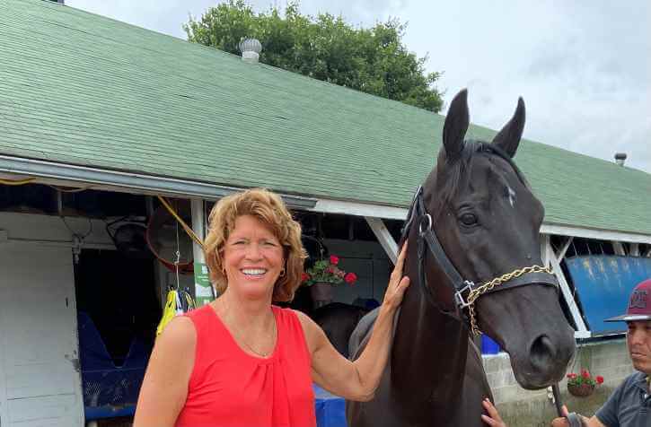 Women's Basketball Coach Chance Dugan poses with her horse, Lamartine