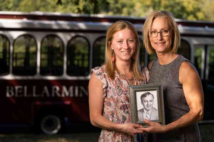 Taylor Jones ’22 and Leslie Cobb ’93 hold a photo of Ben S. Sciantarelli ’61