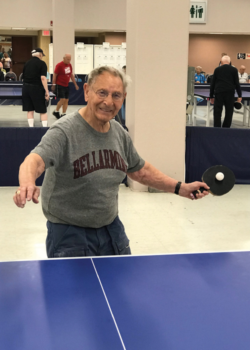 ray Schehr plays ping pong.