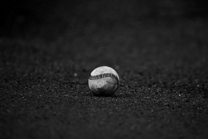 A lone baseball lies on the field