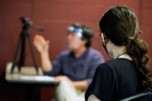 First-year student Greta Reel listens to instructor Gary Fogle, who is using an FM device and a clear mask that help hearing-impaired students.