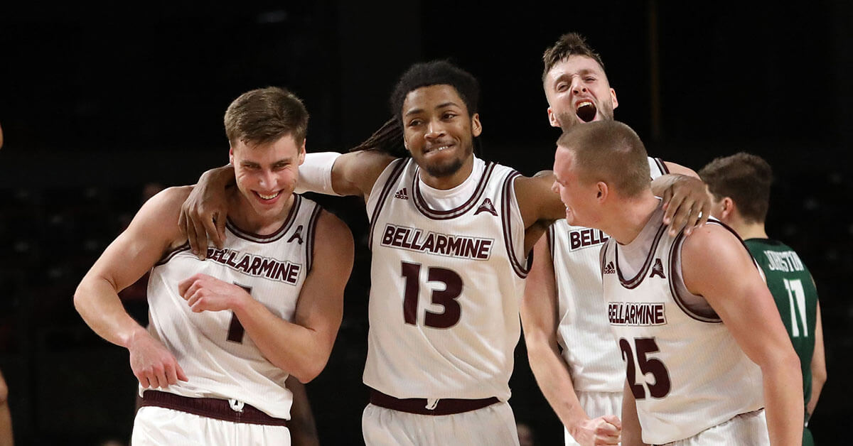 Men's basketball team celebrating on the court