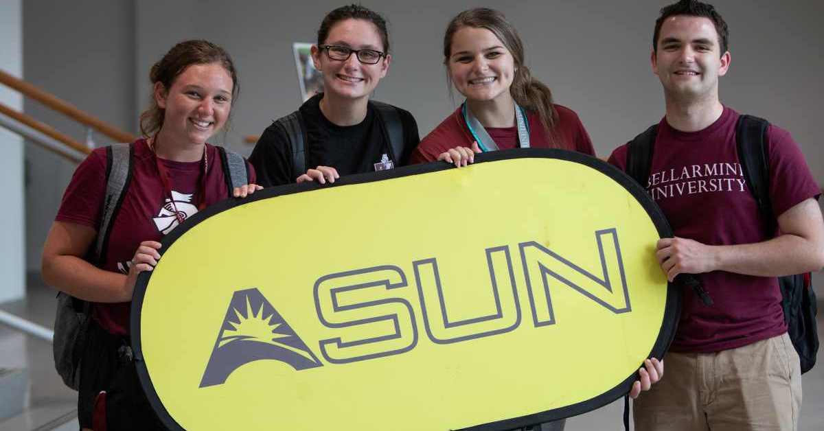 Students hold an ASUN banner at the announcement of Bellarmine's rise to DI