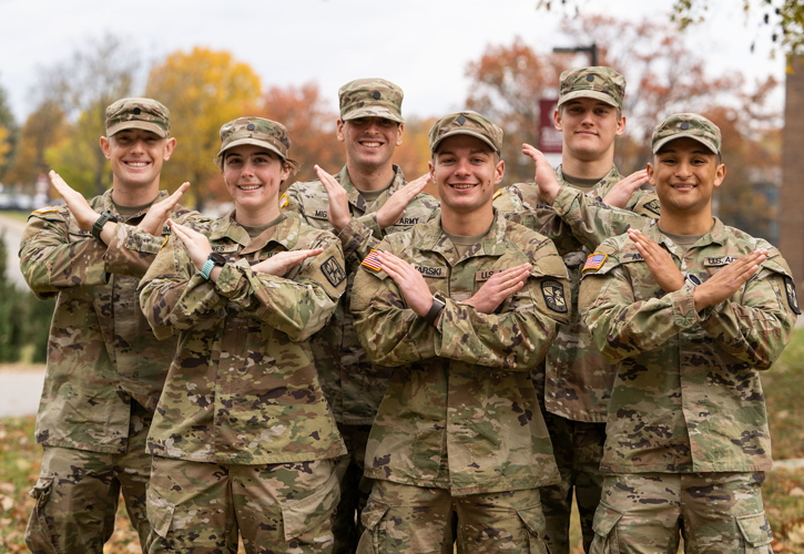 Military students doing the Swords Up pose