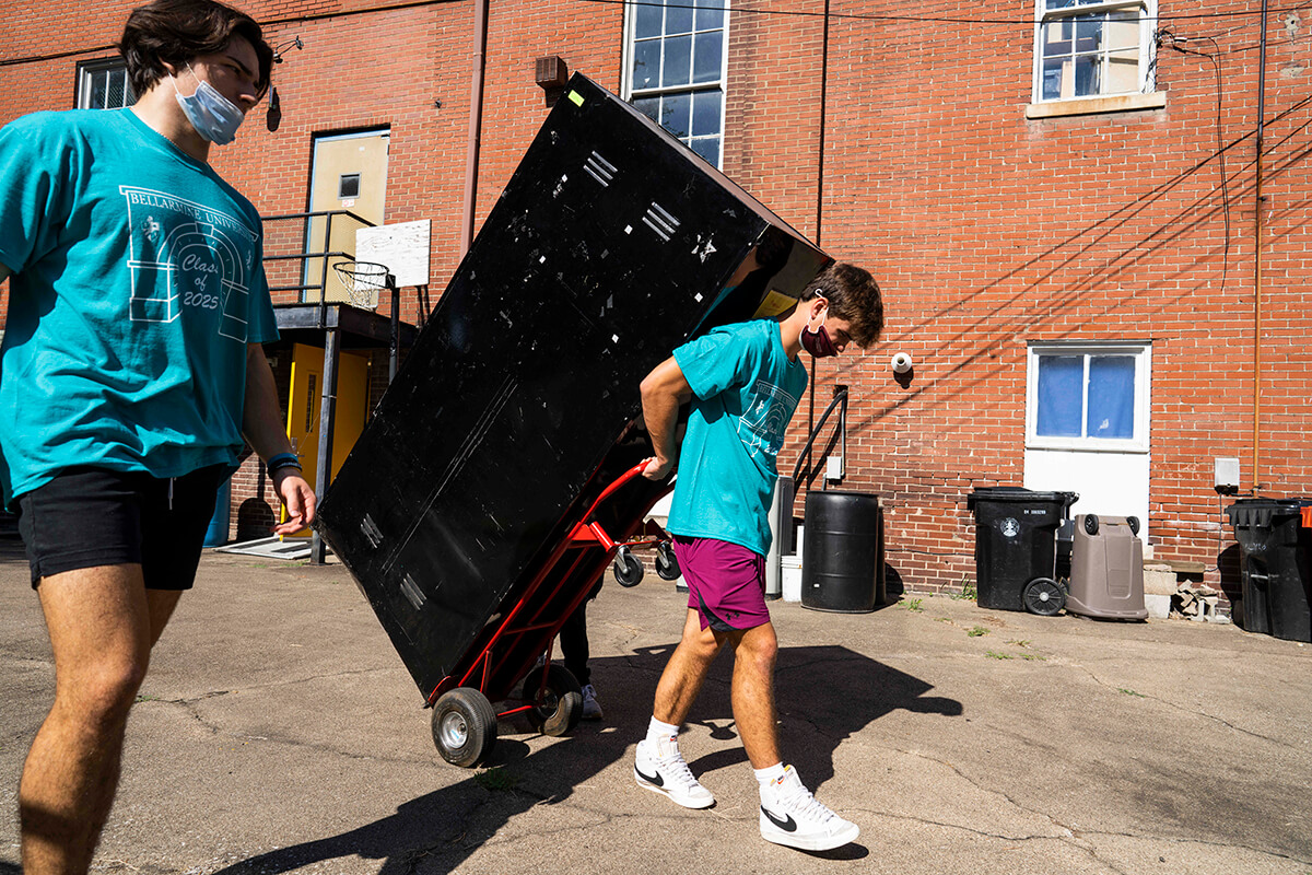 Student volunteer helps move furniture