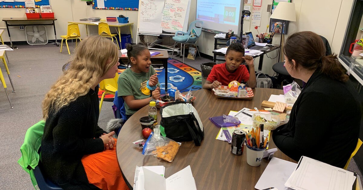 Students around table at Okolona Elementary School