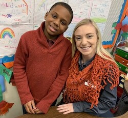 Bellarmine junior Madison Brady spends time with one of the students in Dylan Schafer’s fourth-grade classroom who are writing a play. 