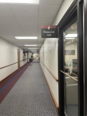 Hallway with a sign for the Financial Aid Office